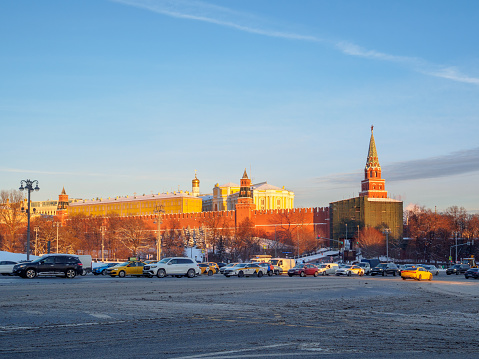 View of the Moscow Kremlin in the sun on a winter evening. Car traffic jam against the backdrop of the Moscow Kremlin. Moscow. Russia. January 19, 2024. High quality photo
