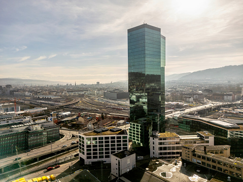 Prime Tower skyscraper at industrial district of City of Zürich, smooth drone flight around the building.