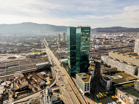 Prime Tower skyscraper at industrial district of City of Zürich, smooth drone flight around the building.