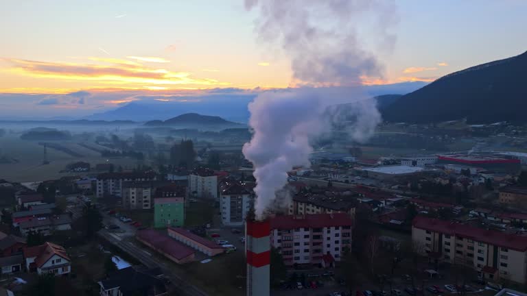 AERIAL Drone Shot of Smoke Emitting From Chimney in Slovenske Konjice During Sunrise