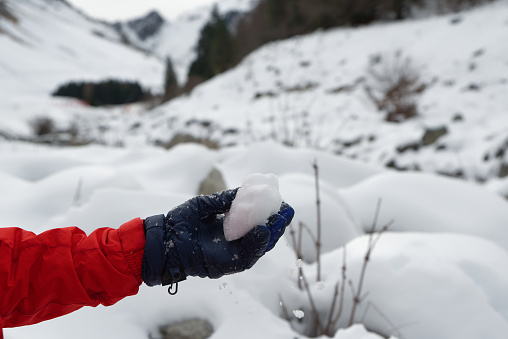 Child playing with snow in the mountains.