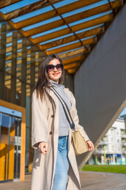 istock Elegant student standing out the university building 1989626477