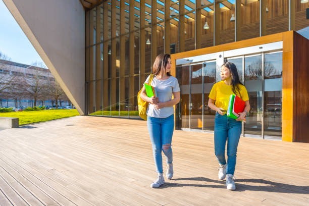 istock Multi-ethnic students chatting and walking along the campus 1989627611