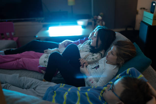 istock Children watching movie at home 1989629335
