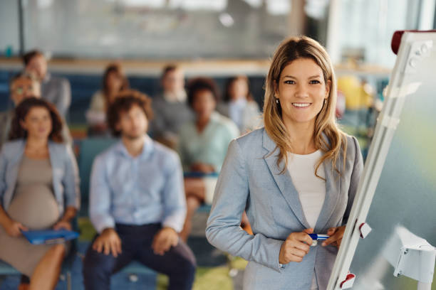 istock Happy female CEO giving a presentation in board room. 1989646916