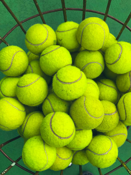 Tennis balls Mound of tennis balls in basket tennis ball container stock pictures, royalty-free photos & images