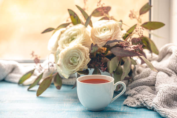 istock Composition with a cup of tea, flowers and a knitted element. 1989663256