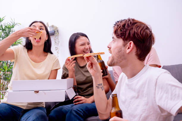 istock Friends laugh eating pizza and drinking beer. 1989696558