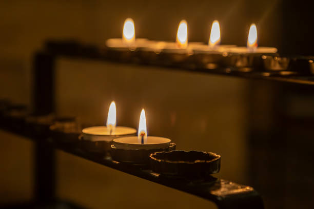 istock Remembrance candles lit in a church, with selective focus 1989733855