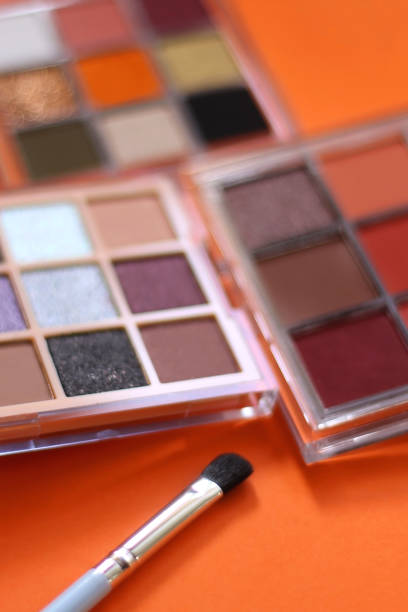 istock Eyeshadow Palettes on Orange Background 1989734895