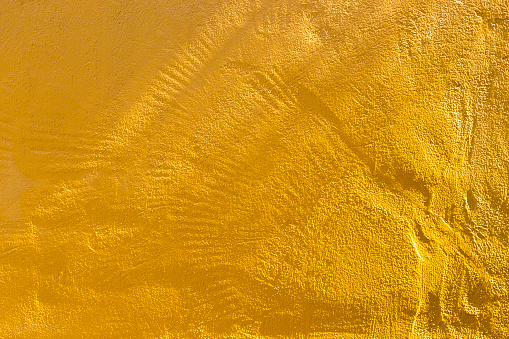 Yellow cement wall with morning day light background, blank yellow concrete wall texture background