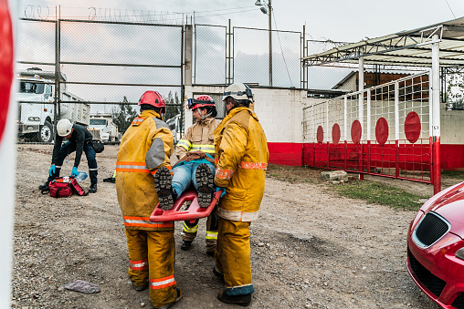 Firefighters helping a accident victim