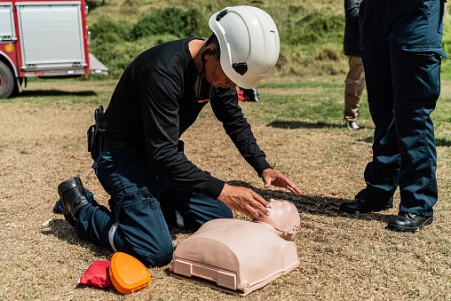 Person practicing on a CPR dummy