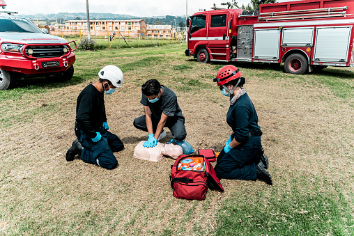 Man practicing CPR on a dummy during a class