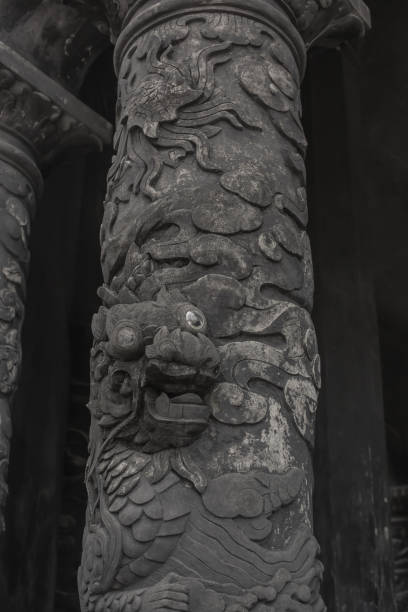 intricate dragon in cloud carvings on ancient stone pillar at historical tomb of khai dinh site, vietnam - etching tan stone textured imagens e fotografias de stock