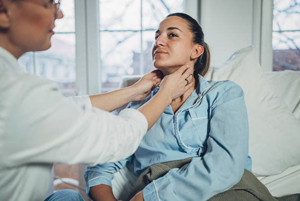 istock Doctor examining woman's throat 1989797397