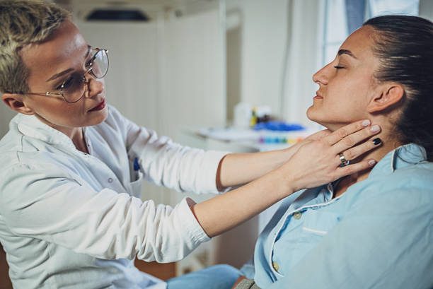 istock Doctor checking thyroid of a patient 1989797963