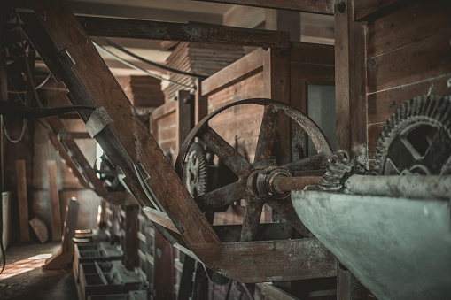 Old wheel on barn wall.