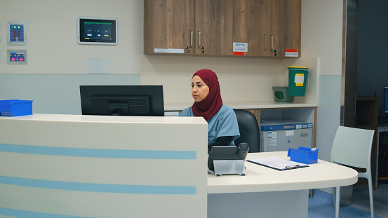 Hospital receptionist sitting at desk