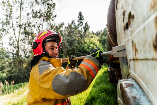istock Firefighter using a crowbar to break down a vehicle door in an accident 1989827177