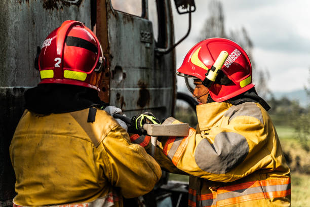 istock Firefighters using a crowbar to break down a vehicle door in an accident 1989827981