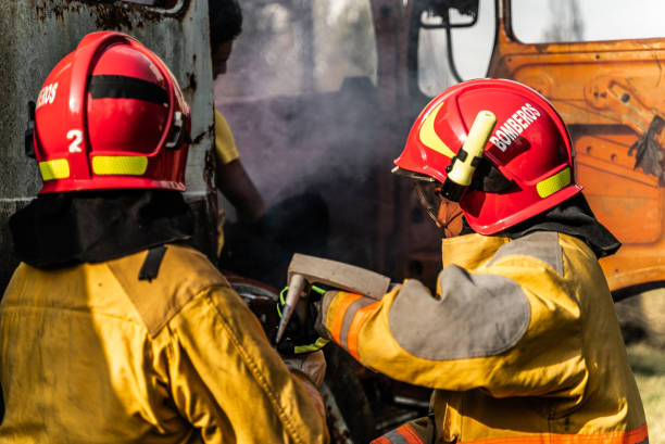 istock Firefighters using a crowbar to break down a vehicle door in an accident 1989828278