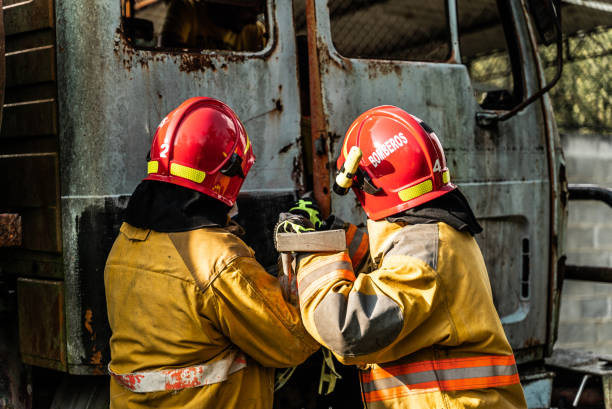 istock Firefighters using a crowbar to break down a vehicle door in an accident 1989828622