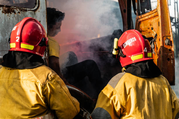 Three firemen hard at work putting out a house fire.