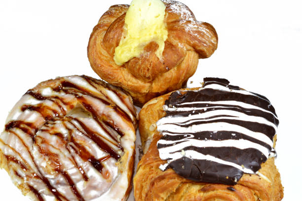 istock Assorted Danish pastry with brown dark chocolate, white chocolate, caramel sauce and pastry cream, sweet bakery dough baked in the oven with flour, sugar and ghee, sweet baked pastry as a snack 1989841707