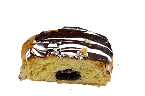 Baked Danish pastry stuffed and topped with brown dark chocolate and white chocolate sauce, sweet bakery dough baked in the oven with flour, sugar and ghee, sweet baked pastry as a snack and breakfast, selective focus