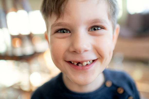 istock Cute little boy smiling with a milky tooth gap 1989844888