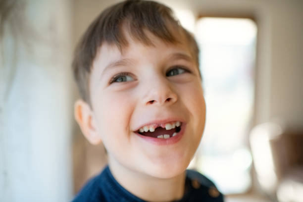 istock Cute little boy smiling with a milky tooth gap 1989844933