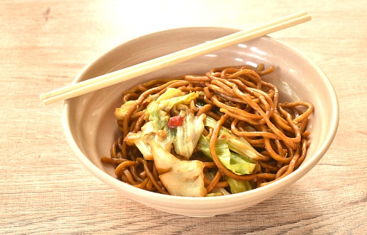 fried yakisoba Japanese noodles and cabbage in spicy sauce on bowl