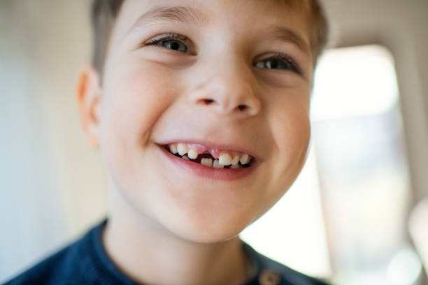 istock Cute little boy smiling with a milky tooth gap 1989845444