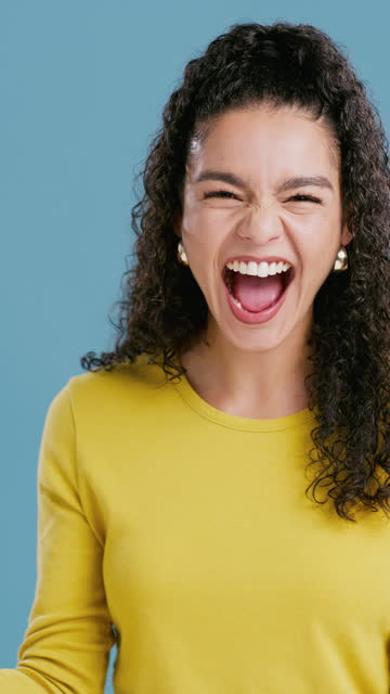 Excited, surprise and face of happy woman in studio with news, celebration or feedback on blue background. Omg, portrait and lady model with winner emoji expression for competition, win and shouting