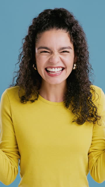 Wow, surprise and face of excited woman in studio with news, review or feedback success on blue background. Omg, portrait or lady model with winner emoji expression for competition, prize or giveaway