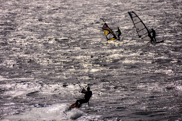 herrsching, germany, october 06,2013 surfers and skaters on lake ammersee in bavaria on a stormy day in autumn
