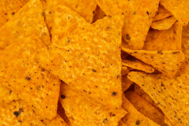 orange mexican nachos chips on white small plate