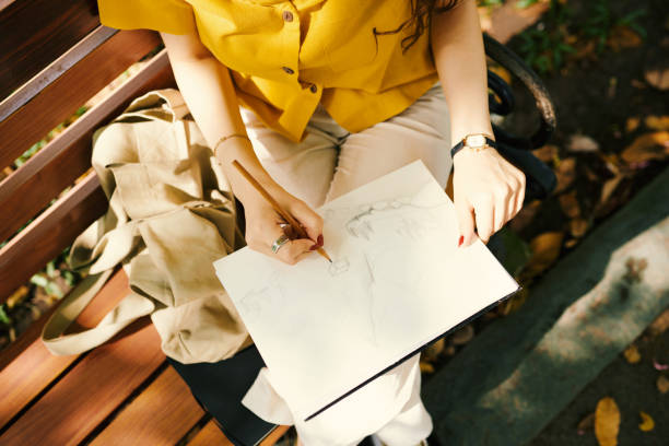 istock Woman drawing on paper with pencil 1989887805