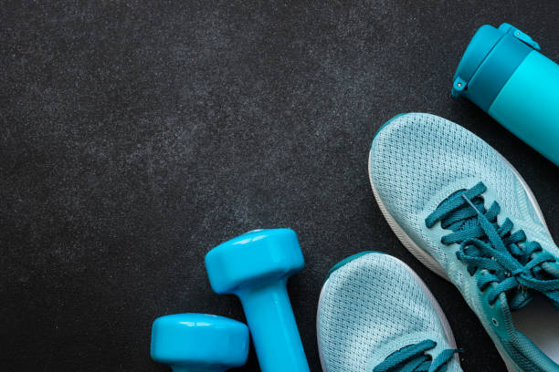 istock Fitness equipment at black background top view. 1989911457