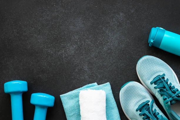 istock Fitness equipment at black background top view. 1989911458