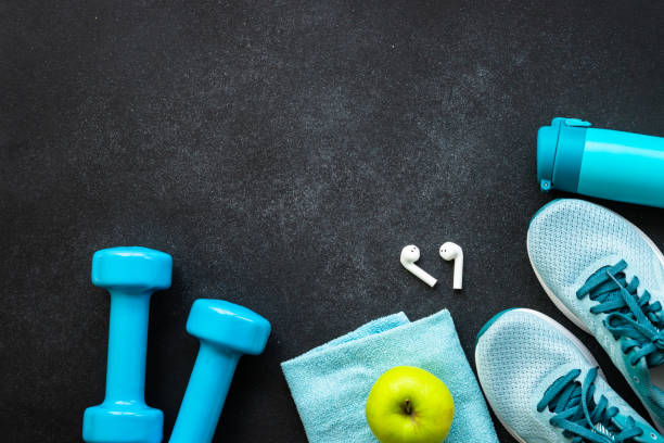 istock Fitness equipment at black background top view. 1989911459