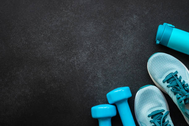 istock Fitness equipment at black background top view. 1989911463