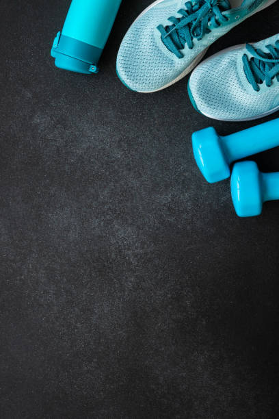 istock Fitness equipment at black background top view. 1989911465