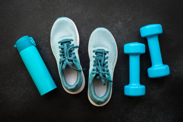 istock Fitness equipment at black background top view. 1989911472