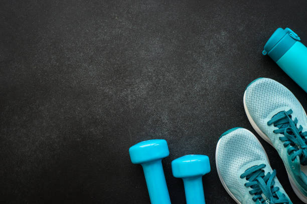istock Fitness equipment at black background top view. 1989913025