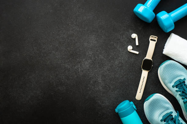 istock Fitness equipment at black background top view. 1989913032