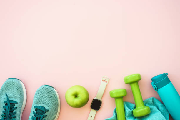 istock Fitness equipment on pink background, flat lay image. 1989914068