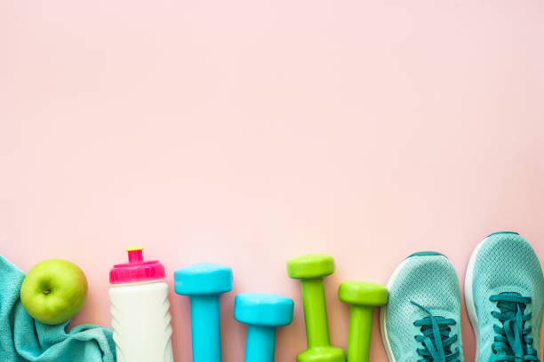 istock Fitness equipment on pink background, flat lay image. 1989914578