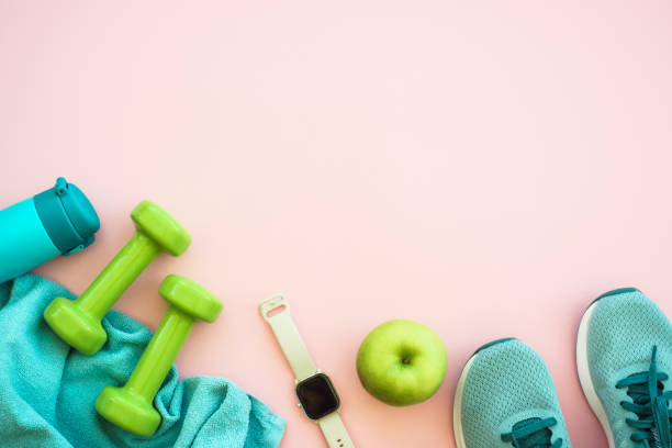 istock Fitness equipment on pink background, flat lay image. 1989919275